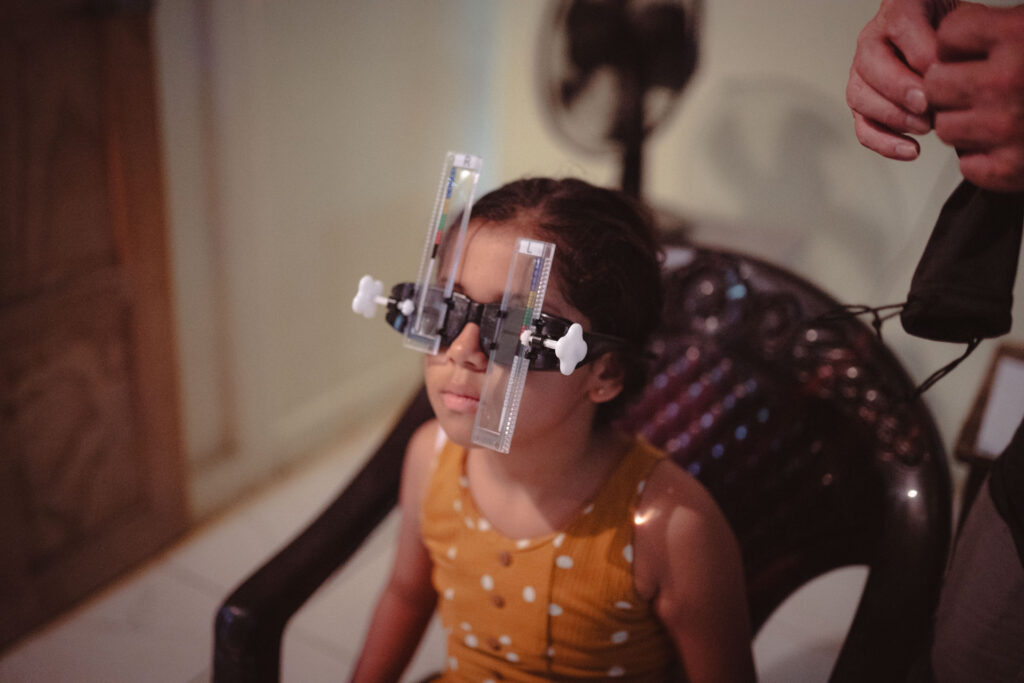 A young costa rican girl with the USeen Vision kit during a think kindness global volunteer project.